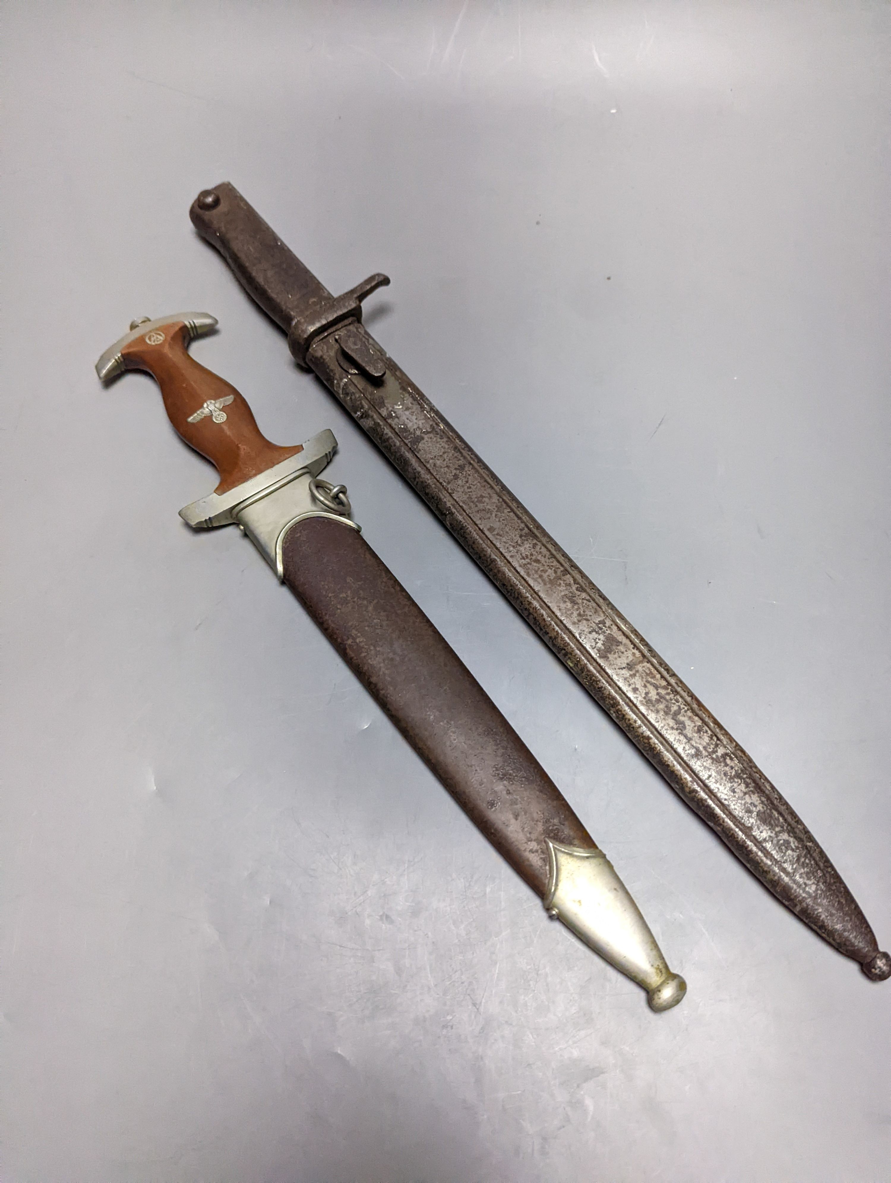 A Third Reich SA dagger within sheath, blade 22cm., and a bayonet within scabbard